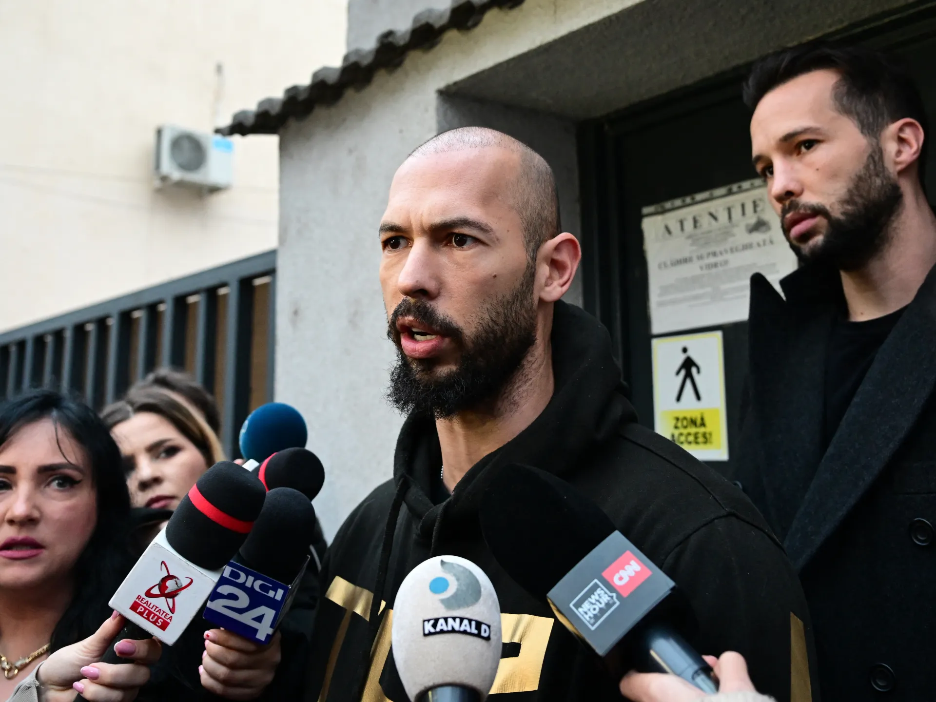 Andrew Tate faces criminal charges and arrests as extradition proceedings continue in the US.
