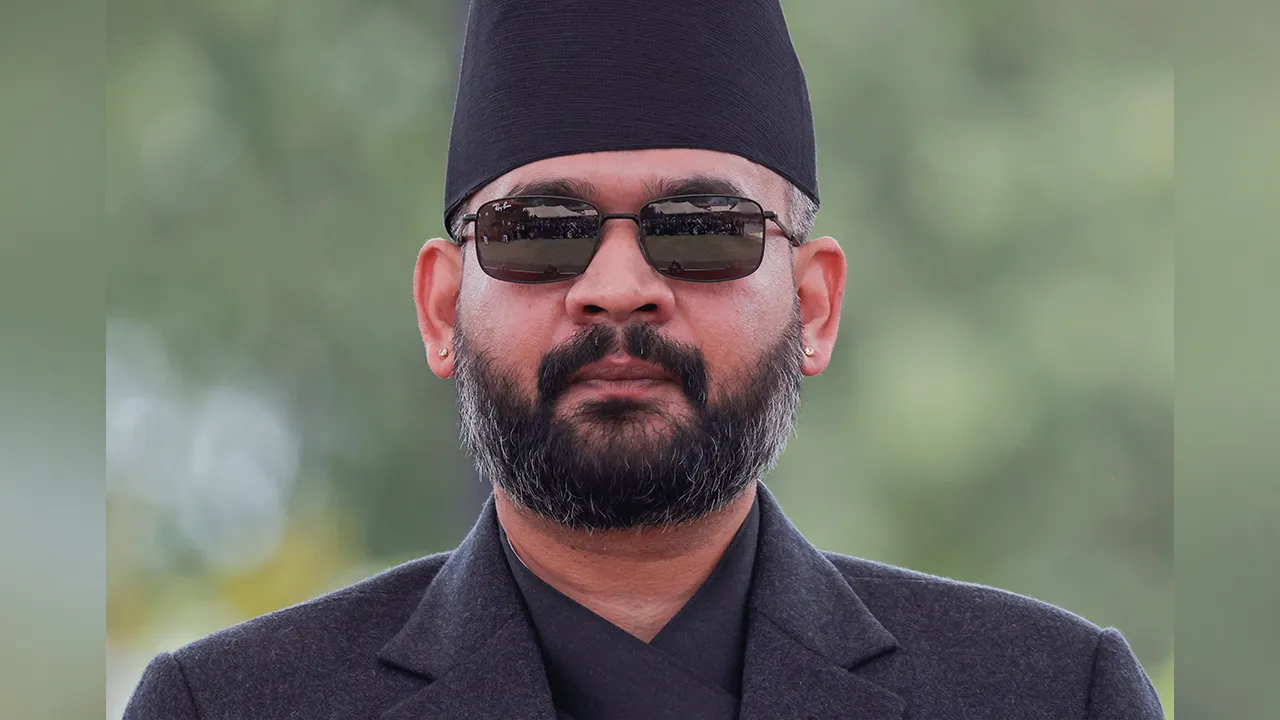 Balendra Shah Nepal prime minister sworn in 2026 wearing signature black cap and sunglasses at President House Kathmandu after Rastriya Swatantra Party wins historic 182 seats in 275 member parliament.