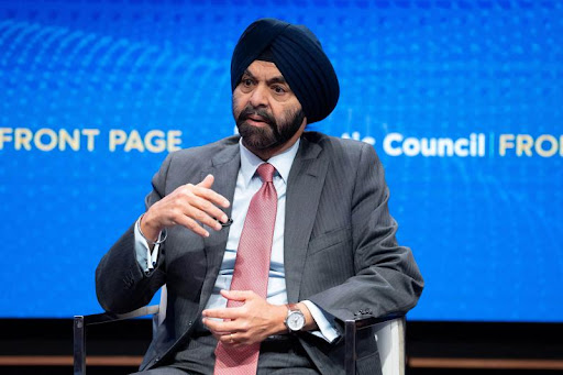 Ajay Banga speaking at event as protesters interrupt, highlighting controversy over World Bank role in Gaza reconstruction fund.
