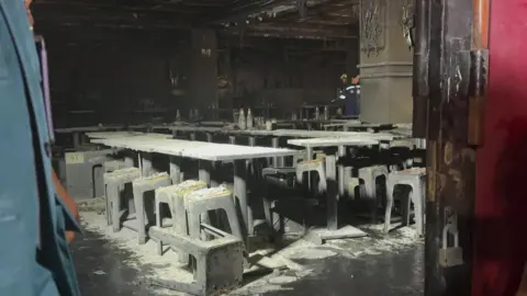Emergency crews respond to a deadly bar fire in Bangkok as firefighters battle flames and rescue injured victims.