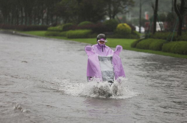 Floodwaters cover streets in northern China as stranded vehicles and emergency teams respond to severe flooding.