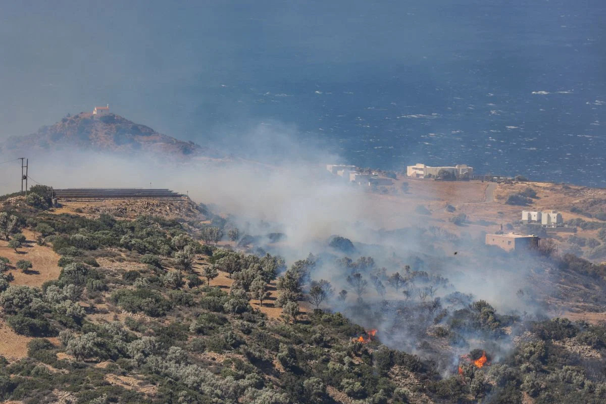 Aerial view of wildfire smoke columns rising simultaneously over pine forests in France near Bordeaux, olive groves in Crete Greece, and scrubland in Spain's Castellon province during Europe's record 2025 summer wildfire season