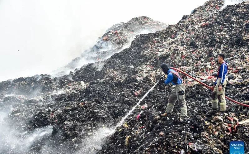 Firefighters tackle a massive landfill blaze in Indonesia as thick smoke blankets nearby neighborhoods.