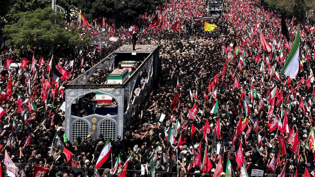 Crowds gather in Tehran during the state funeral procession for Iran's former Supreme Leader amid tight security.