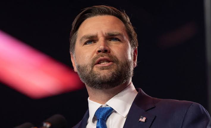 JD Vance speaking at a political event amid controversy over his speeches, immigration views and public remarks.