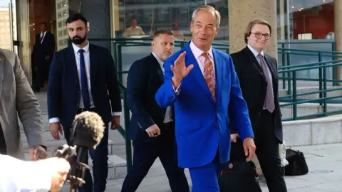Nigel Farage addresses supporters as the Clacton by-election begins amid a parliamentary standards investigation.