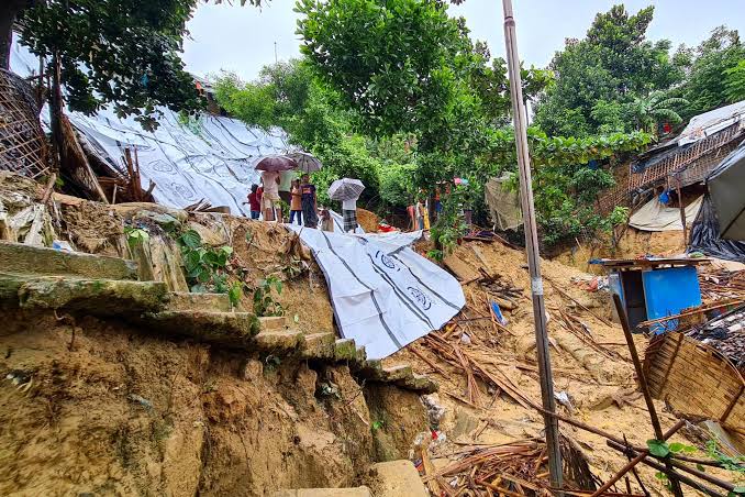 Rescuers search damaged Rohingya refugee shelters after monsoon-triggered landslides in Bangladesh.