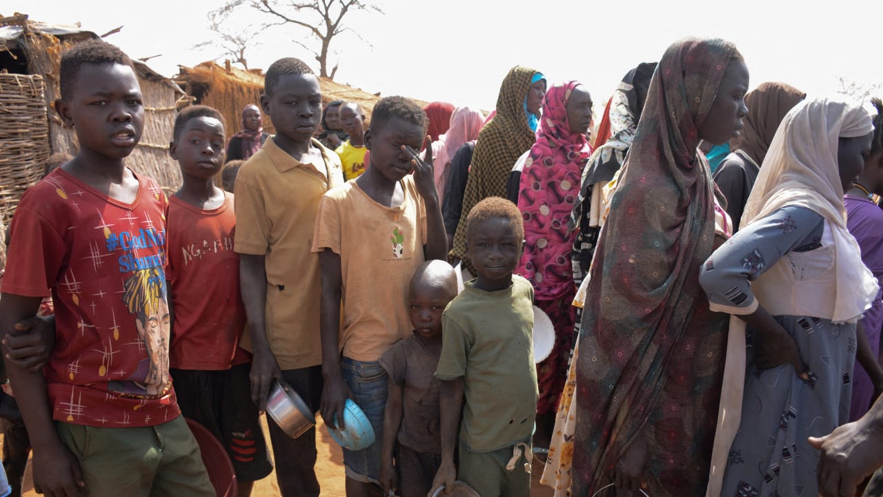 Starving families in Sudan amid conflict, with food shortages forcing people to survive on minimal meals daily.