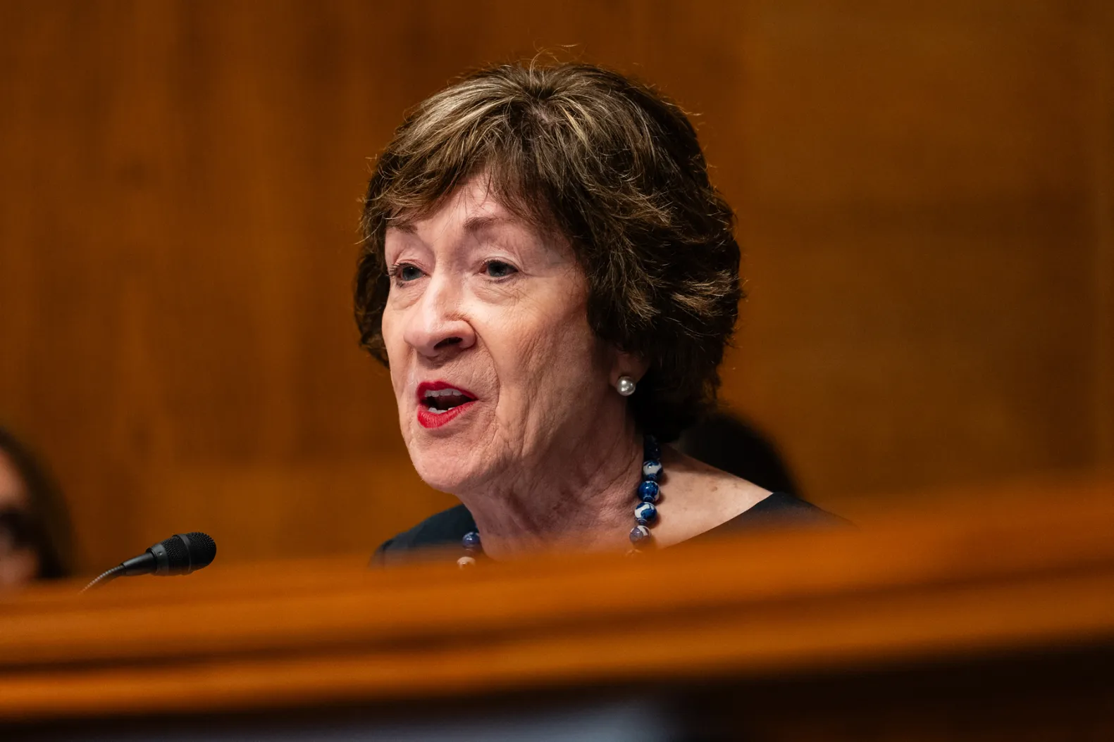 Susan Collins faces scrutiny over alleged campaign donations and defense contracts linked to a former military contractor.